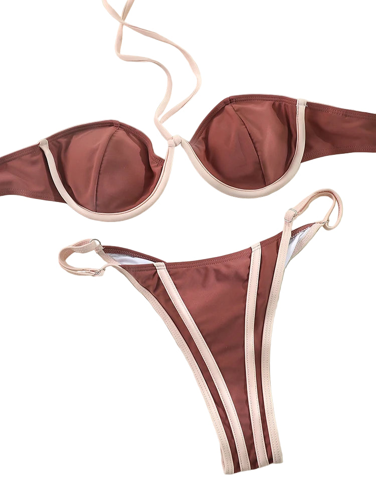 Flat lay of the Sunset Dune Bikini in brown with contrast trim, featuring halter top and matching bottoms on a neutral background