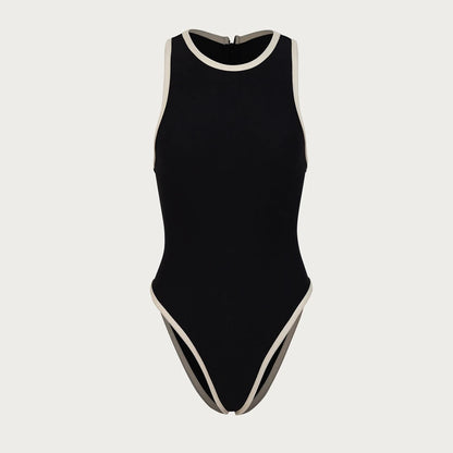Flat lay of the Midnight Wave One-Piece Swimsuit in black with white edging and halter neckline